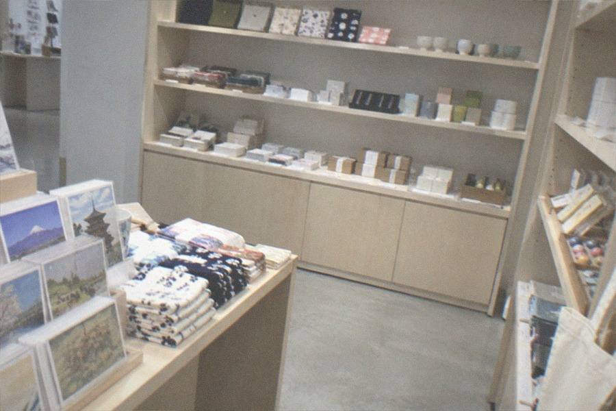 A toppings counter with rows of dried ingredient canisters in a noodle workshop