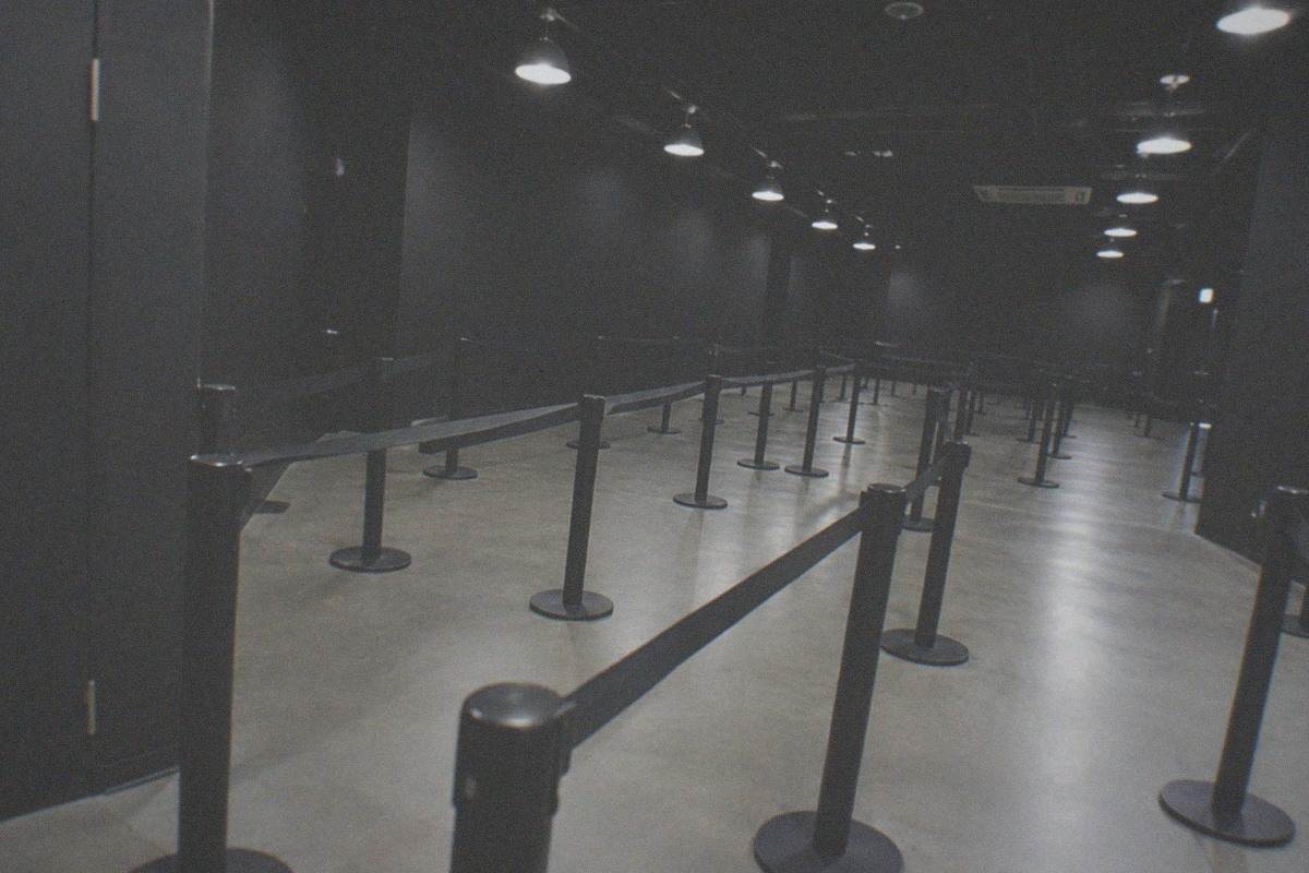 A dimly lit studio corridor with hanging lanterns and a brick platform backdrop at a film studio attraction