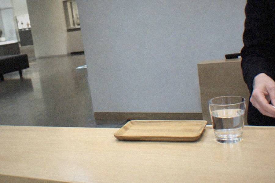 A phone and notebook on a desk showing a ticket booking confirmation screen beside a rail pass