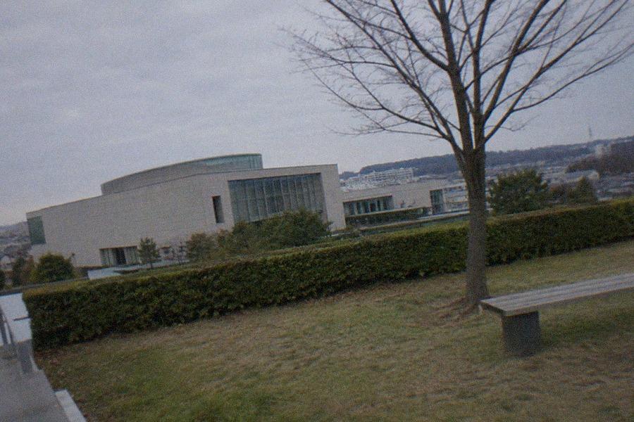 Visitors approaching the entrance of the Fujiko F. Fujio Museum in Kawasaki, where a Doraemon statue stands outside the building